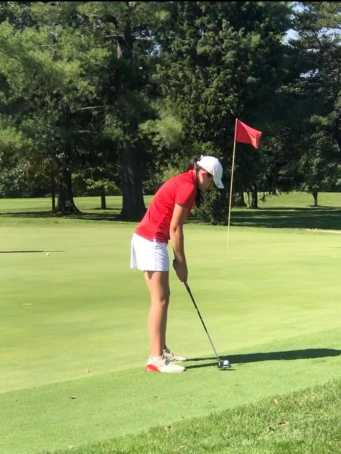 Senior Molly McLean putts from off the green in a regular season golf match at Parkersburg Country Club.