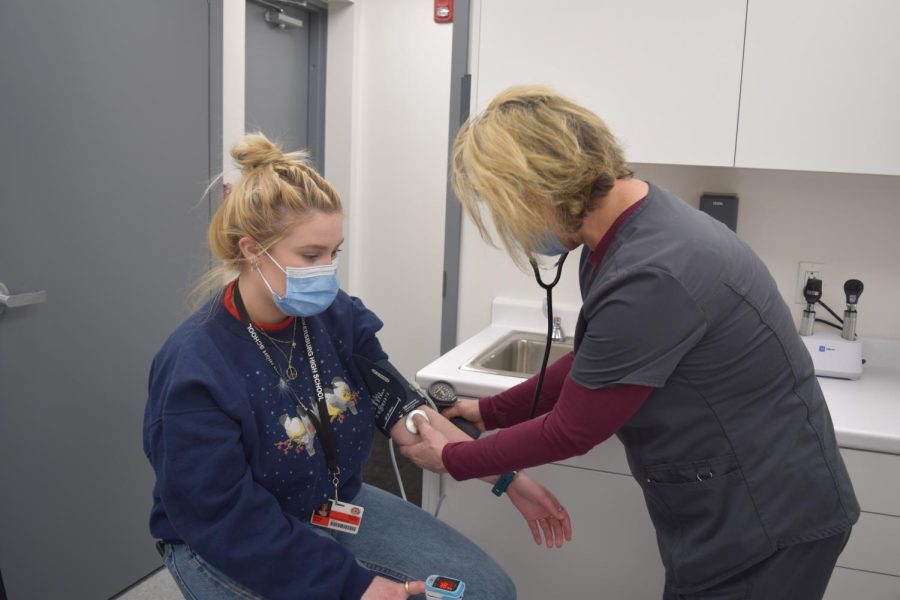 Junior Kate Hayes gets her blood pressure taken at the new Coplin Health Center by Nurse Tia Payne.