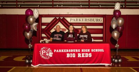 Senior Rylee Wise (center) sits between her parents Mike Wise and Trish Wise in the Fieldhouse on Nov. 16 after signing to play volleyball at Concord University.