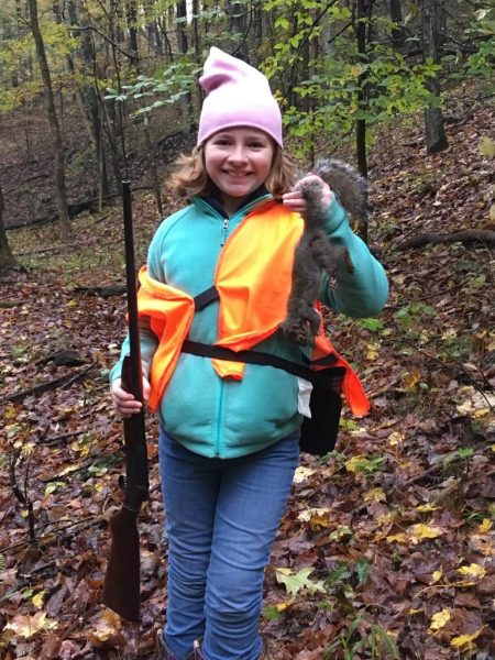 The writer at 11 years old with her first squirrel. 