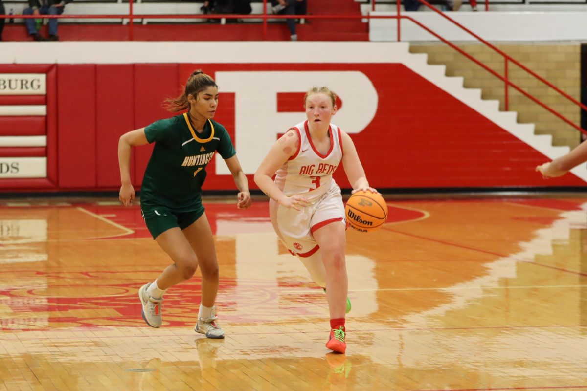 Senior Trinity Balog dribbles down the court during a home game against Huntington on Jan. 30.