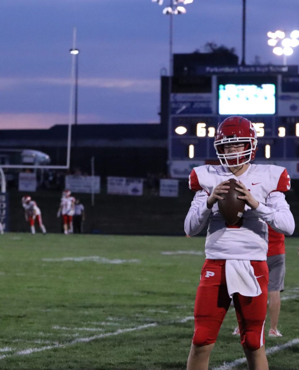 Senior quarterback Cooper Cancade stays warm on the sidelines.