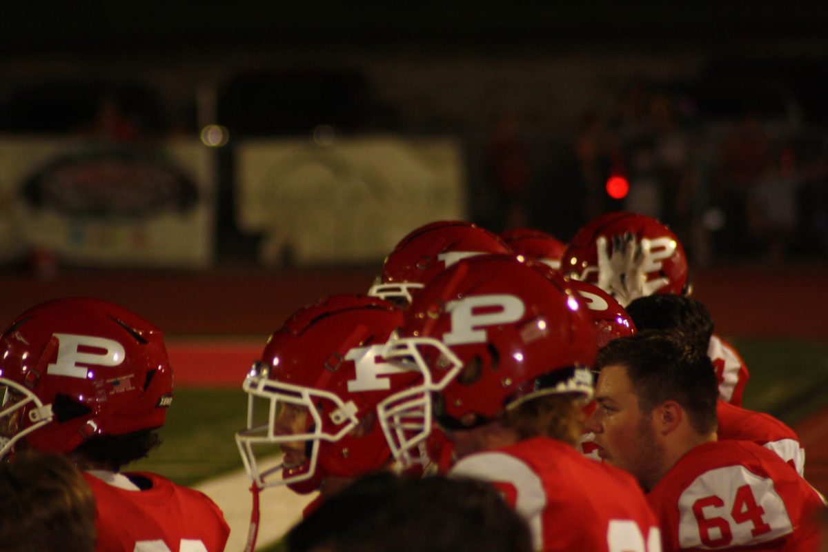 Football players standing on the sidelines.