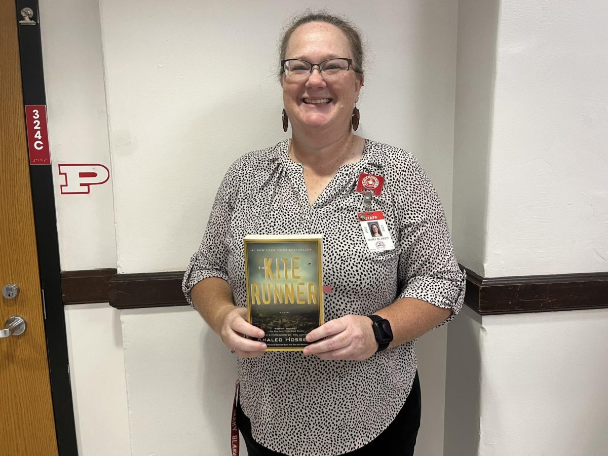 English teacher Mary Blaker with her favorite banned book, “The Kite Runner”.