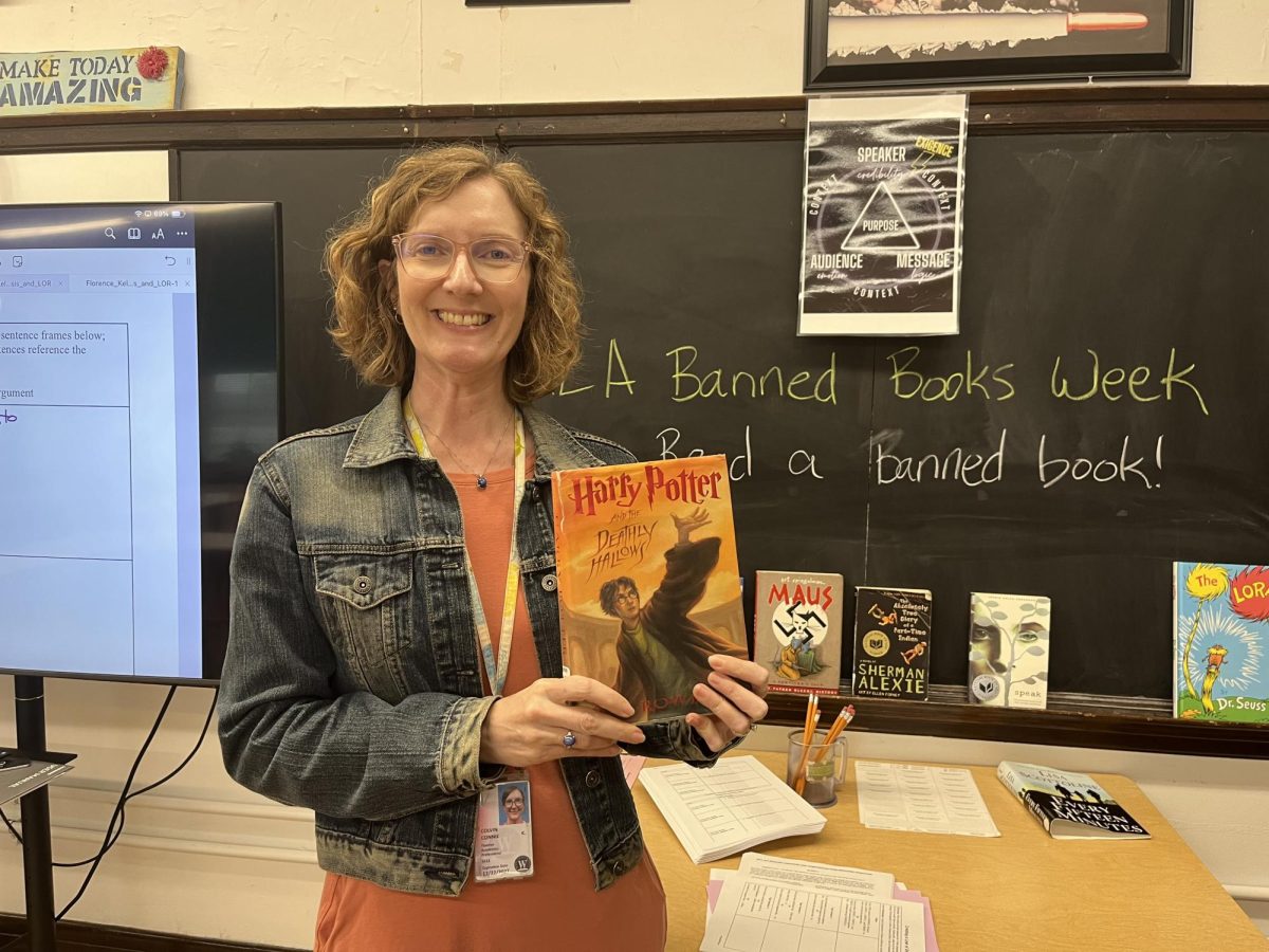 English teacher Connie Colvin with her favorite banned book, “Harry Potter and the Deathy Hallows”.