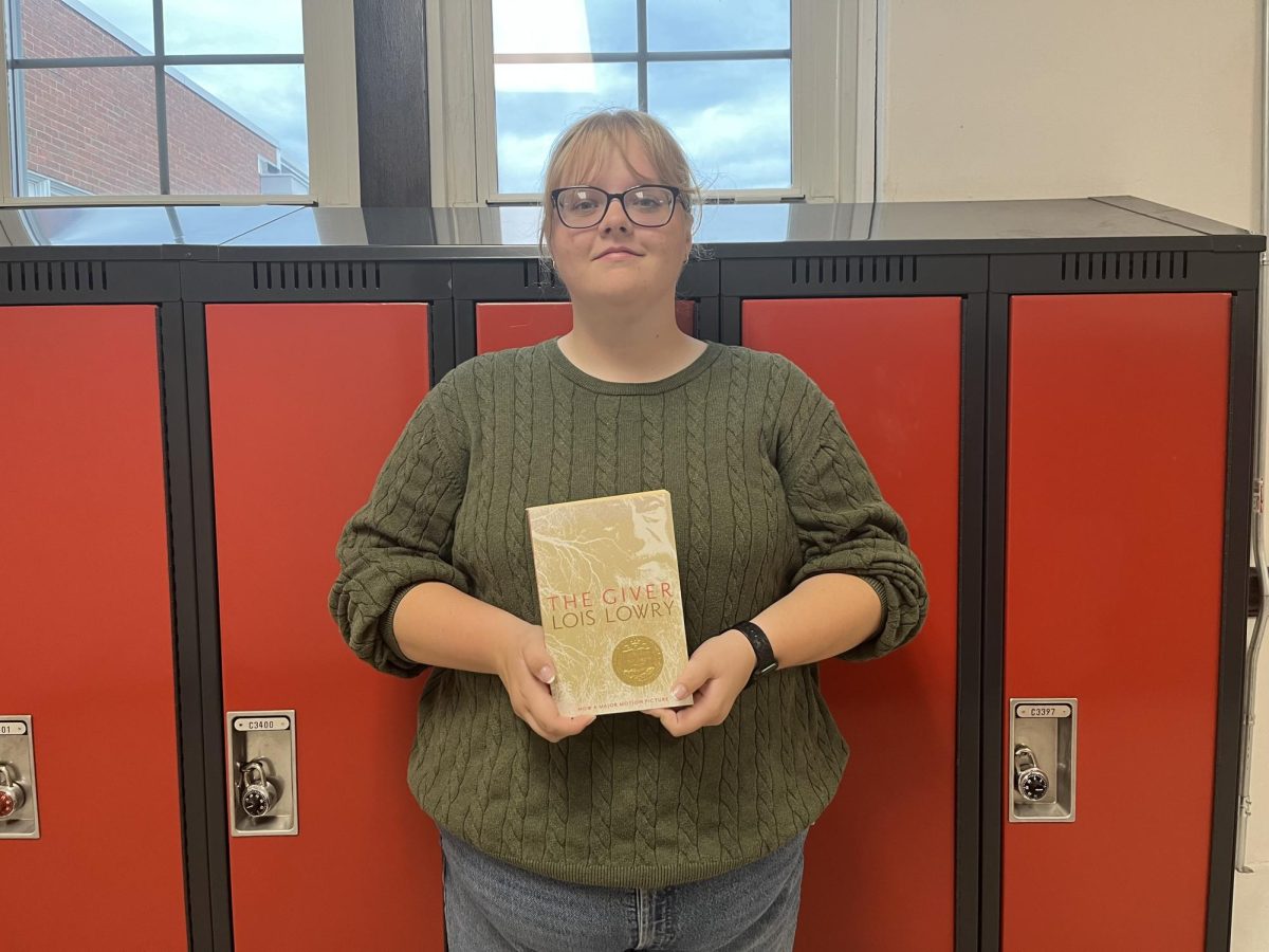 Junior Samantha Bailey holding her favorite banned book “The giver”.