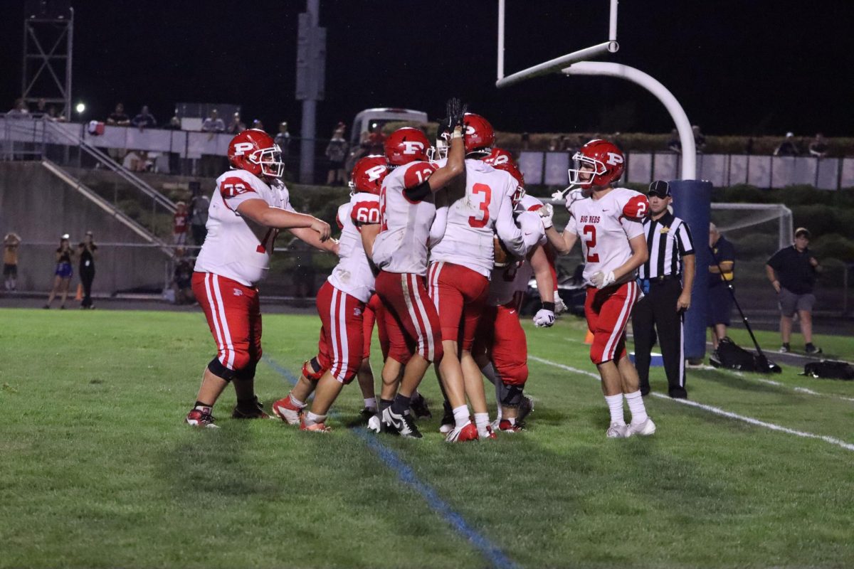 Senior quarterback Cooper Cancade (3) celebrates with his team after scoring a touchdown. 