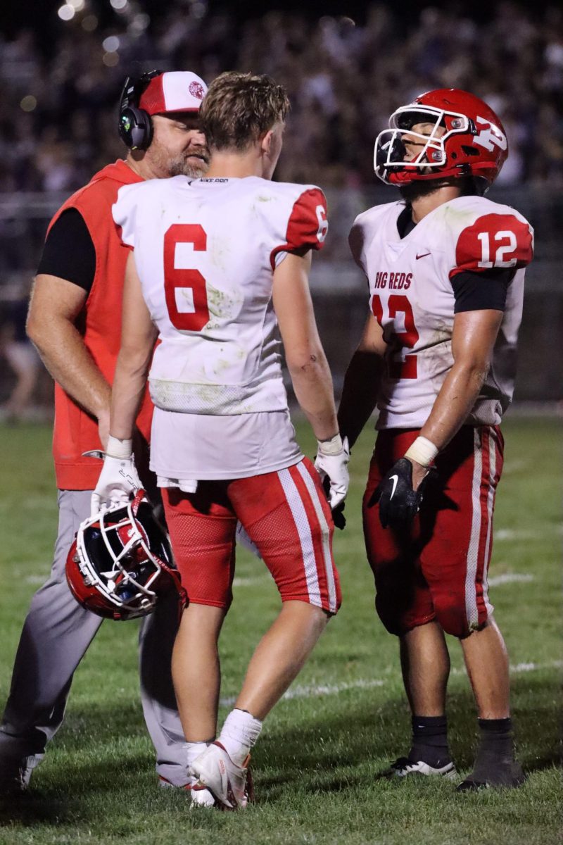 Seniors Connor Petty (6) and Jakel Shelton (12) talk with head coach Matt Kimes during a timeout.