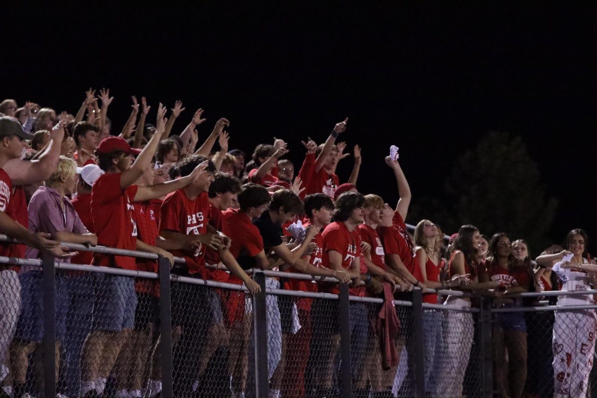 Students reach for t-shirts being thrown by the cheerleaders.