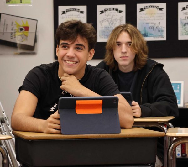 Junior Will Hopkins reads critical thinking questions to his AP Language class during a socratic seminar Dec. 16. The class analyzed questions relating to the play "The Crucible" by Arthur Miller.