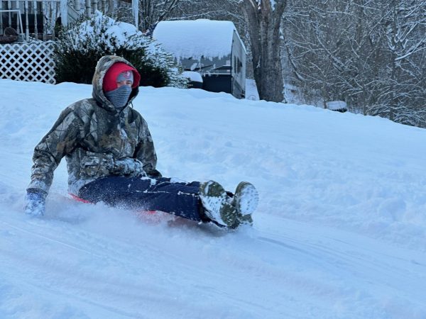 Freshman Douglas Casto sleds on Jan. 9 during the fourth snow day of the year. 