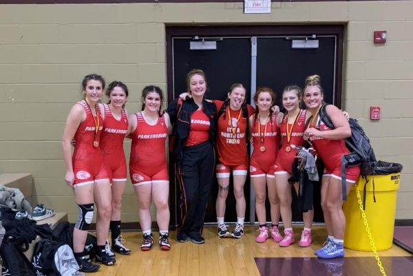 Members of the girls wrestling team pose for a picture after receiving their medals at their first meet of the season, the Lady Jacket Throw Down, on Dec. 7.