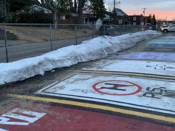 In a photo taken Feb. 4, the parking lot is covered in snow and trash.