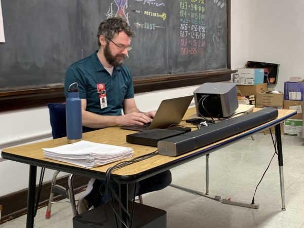 Film Studies teacher Andrew Moore works at his desk.