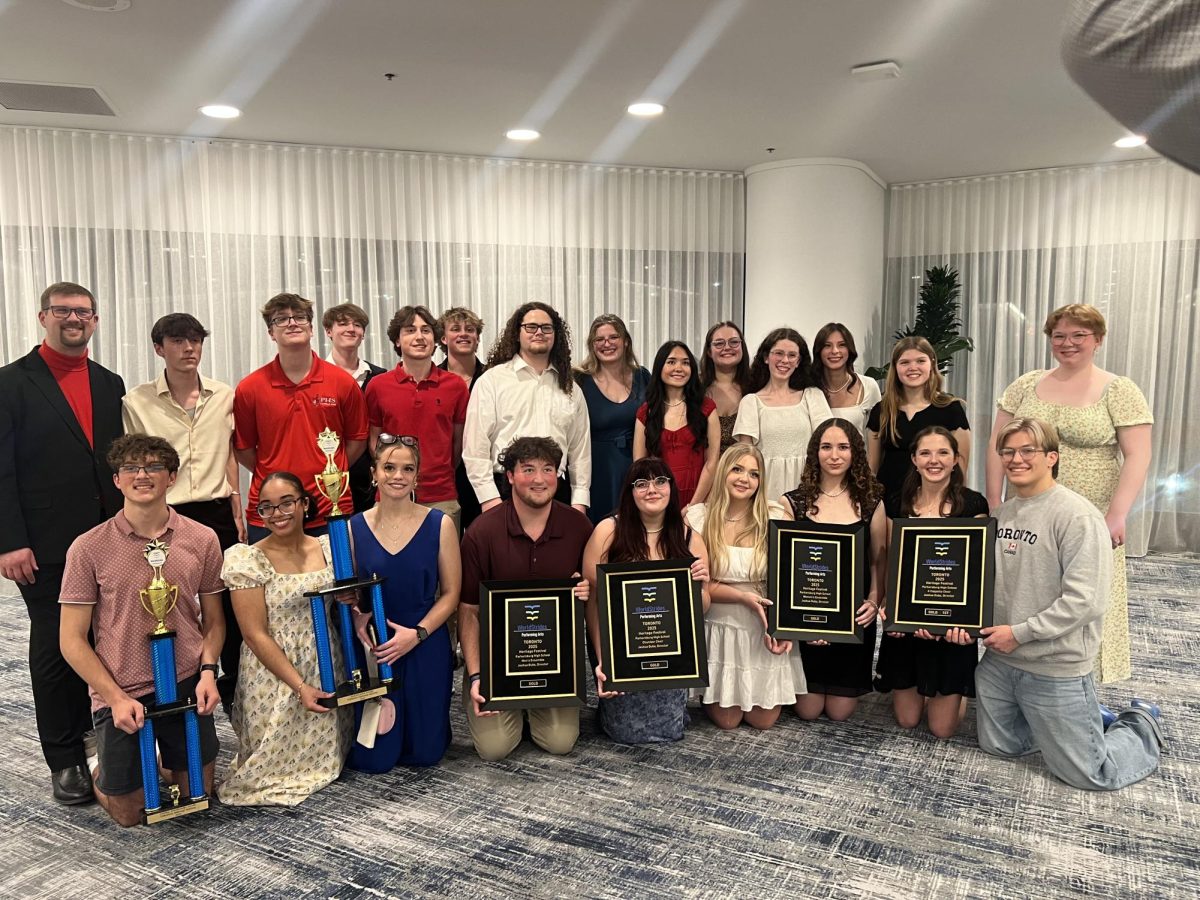 A Cappella Choir seniors displaying the choir's awards after the awards ceremony in Toronto. 