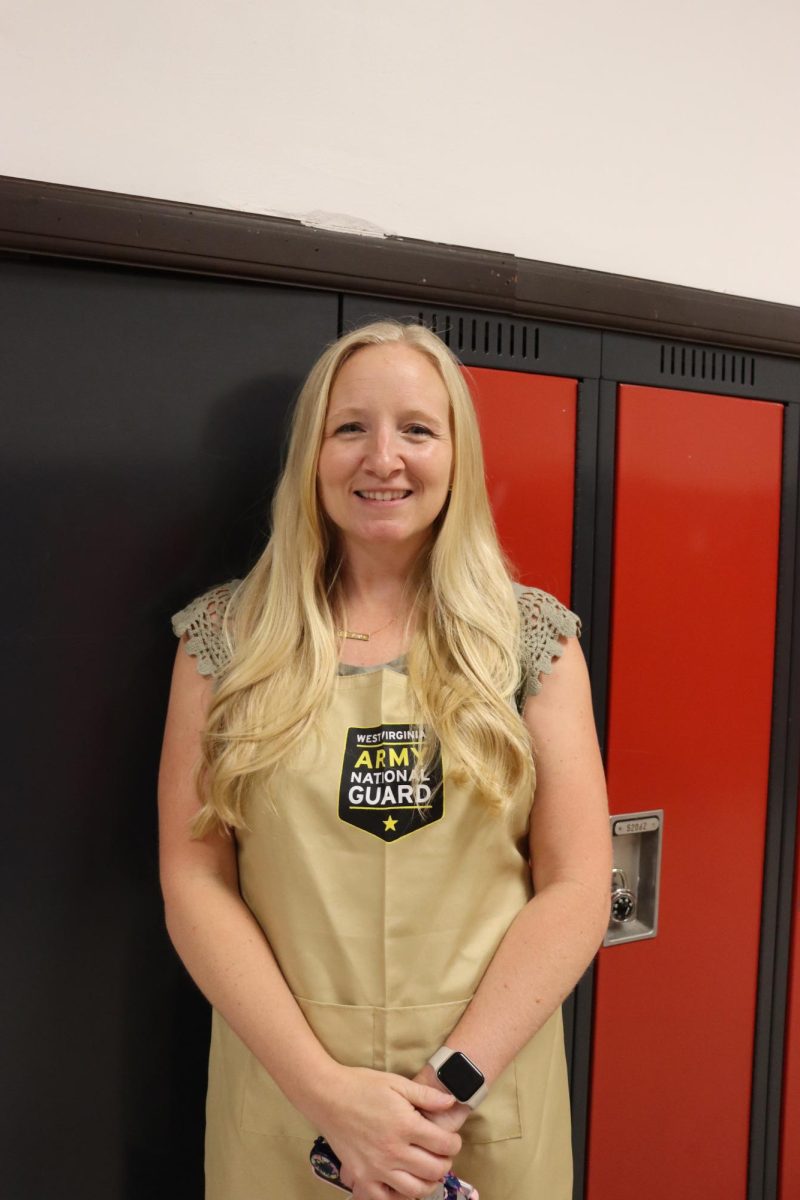 Baking teacher Alyssa Smith standing in front of lockers by her classroom. 