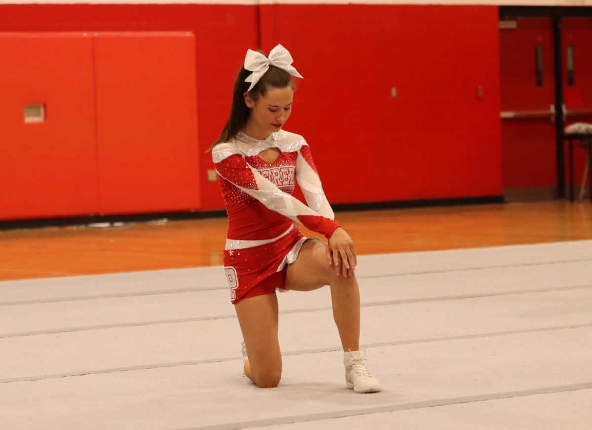 Senior Baylee Bostaph before performing at the cheer team's friends and family night in the Jack Stephens Gym.