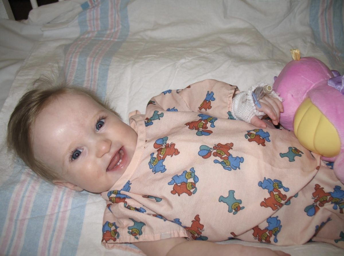 Me, five days after my surgery, smiling in my hospital bed.