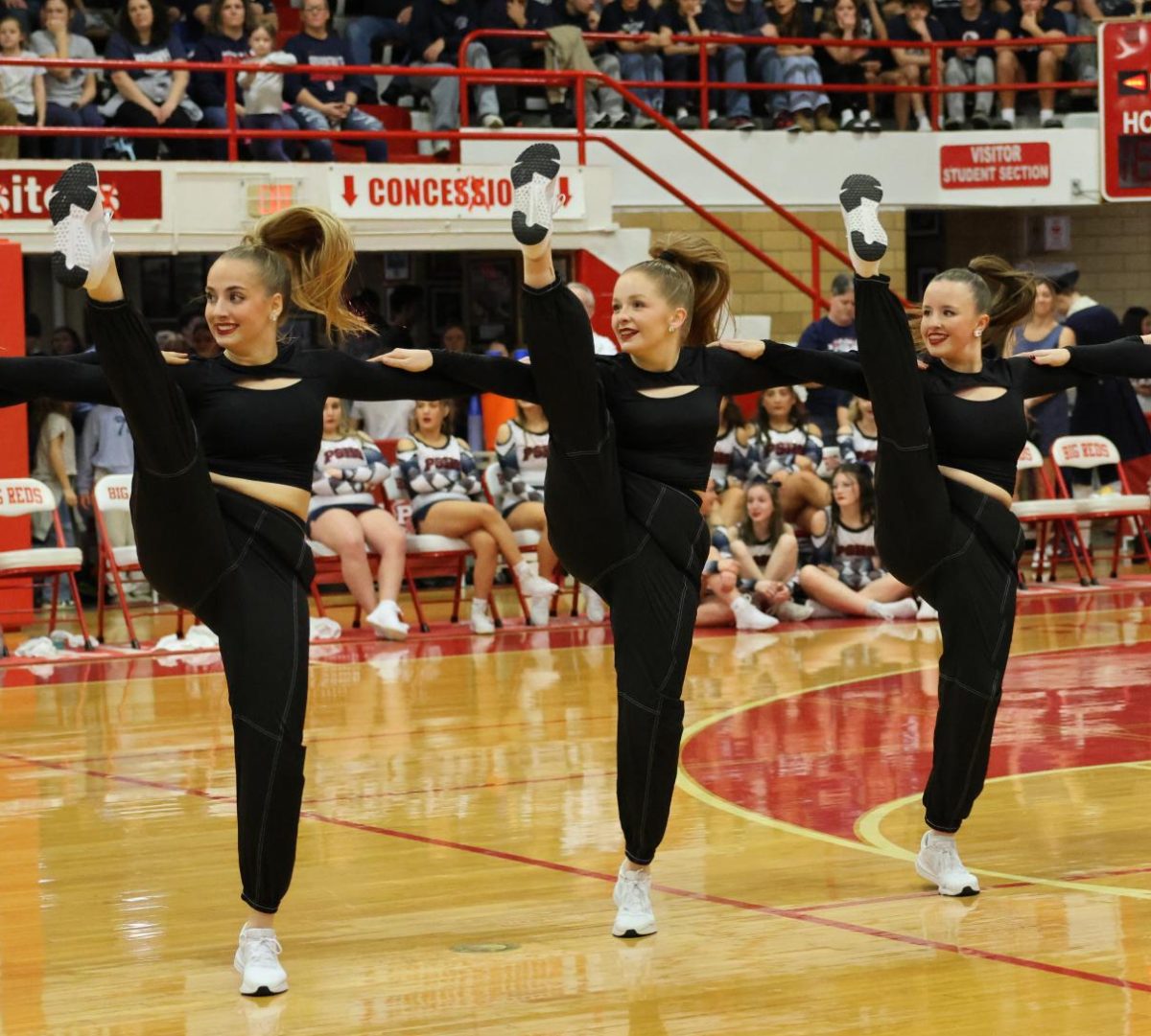 Sophomore Aeriana Nicolai, senior Brooklyn Miller and freshman London Nelson during the Red Wing Drill and Dance Team's halftime performance for the Rivalry Week boys basketball game in the Fieldhouse Jan. 10.