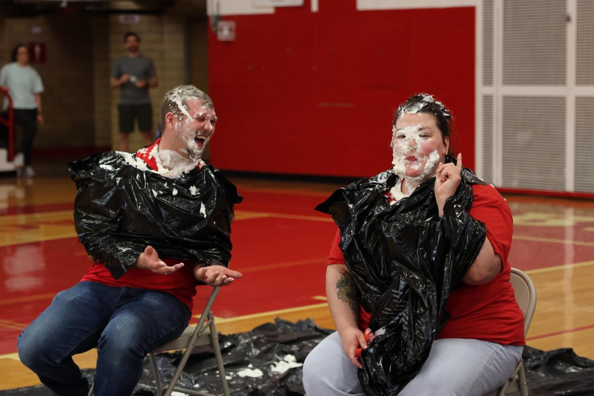 During the spring thuse April 23, 2025, choir director Joshua Dubs and history teacher Katelyn Parker react after getting pied in the face. 