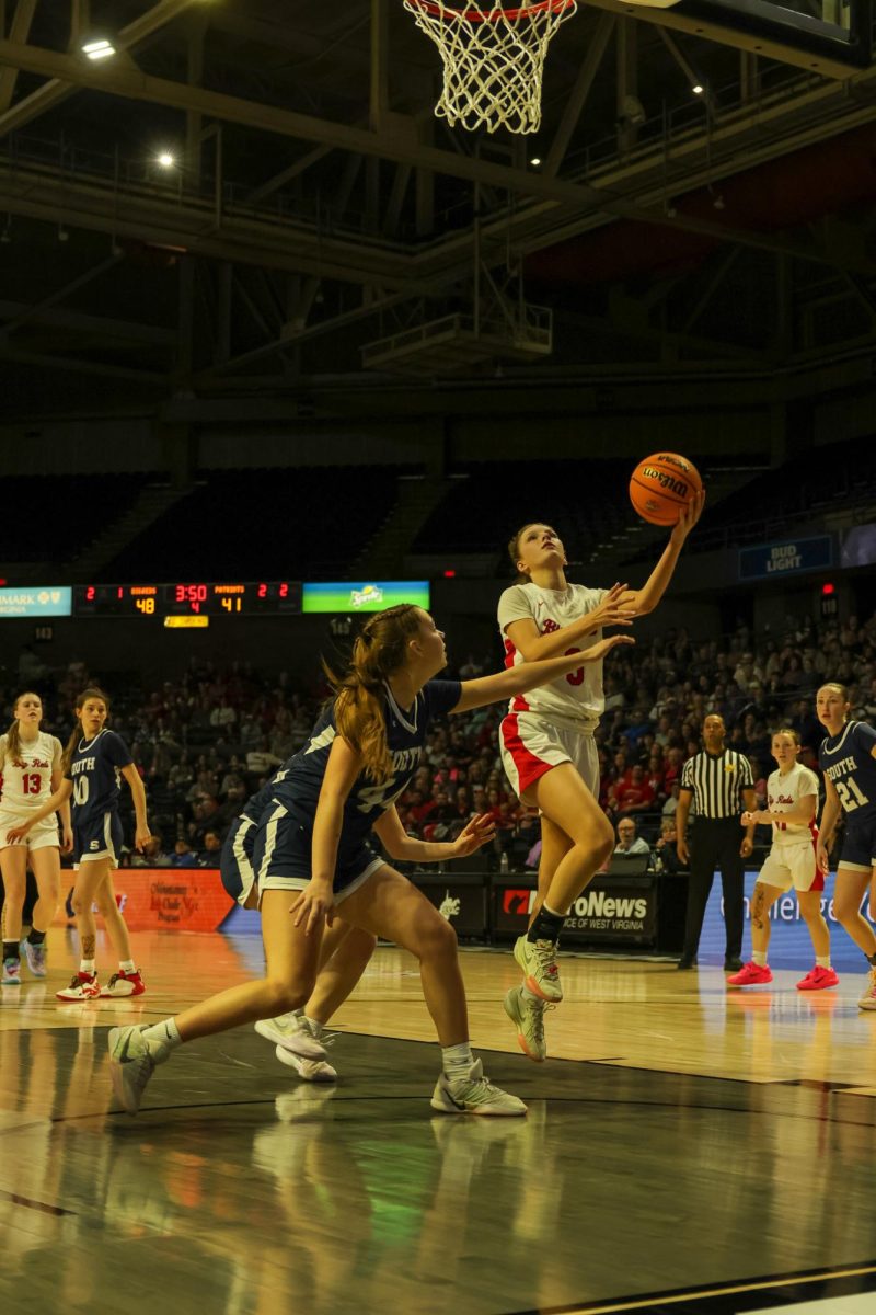 Junior Frances Guice goes up for a hook shot March 14.