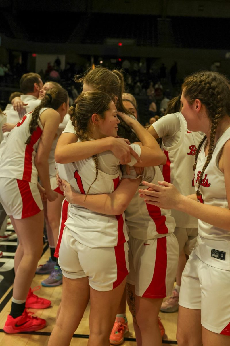 Senior Lauren Flanagan, junior Frances Guice and sophomore Faithlyn Butcher hug after winning the state championship March 14.
