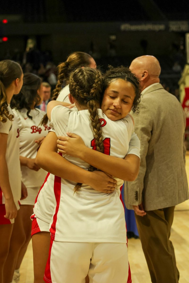 Junior Amaya Lewis hugs sophomore Faithlyn Butcher March 14.