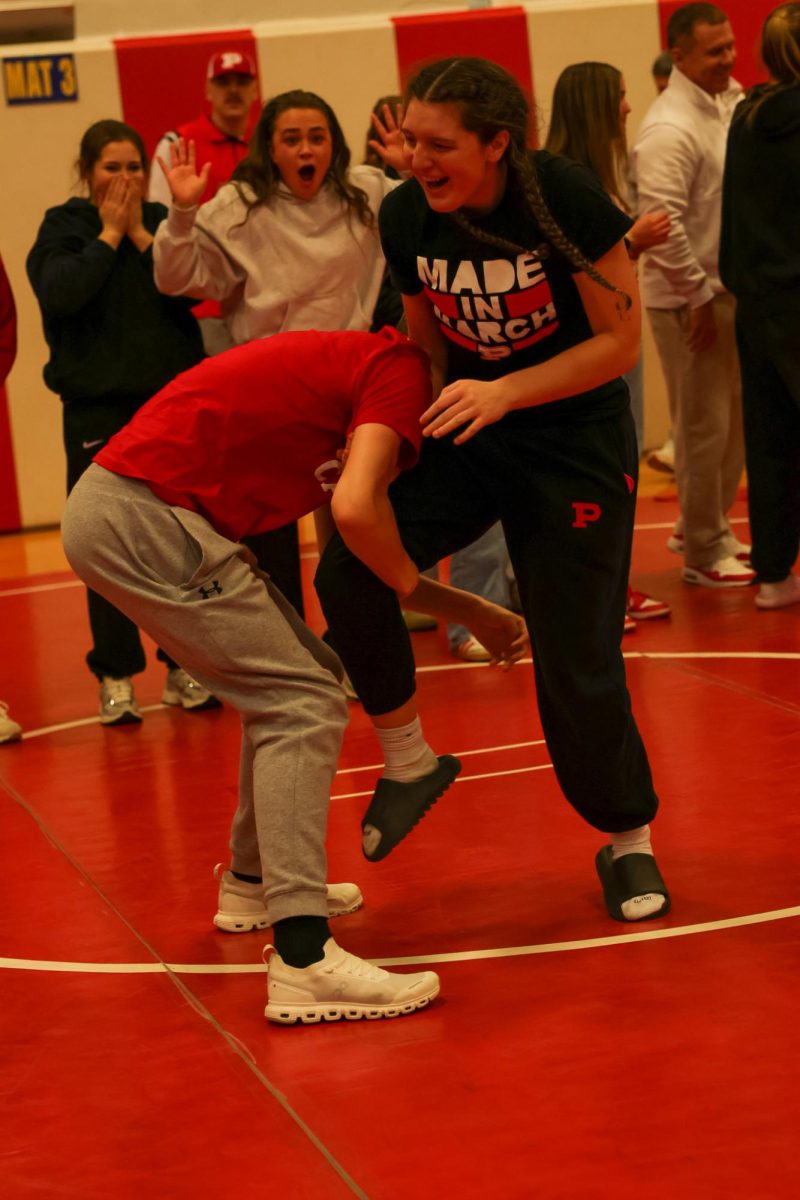 Seniors Tanner Cancade and Kenslee LeMasters wrestle in the Fieldhouse March 14.