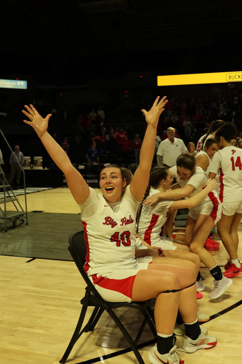 Senior Kennedy Porter celebrates towards the crowd March 14 before the awards presentation.