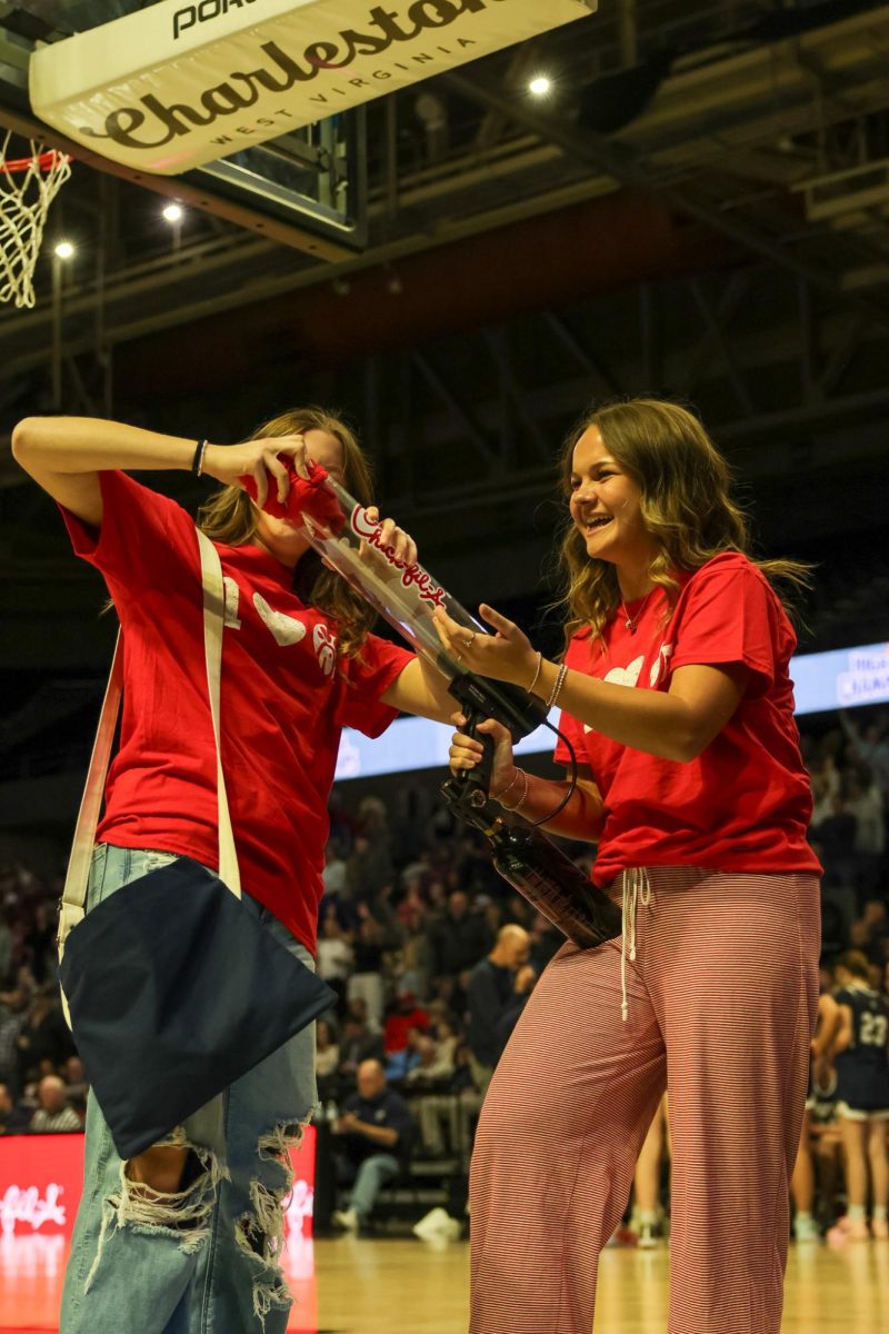 Junior Calli Angelos helps with the Chick-fil-A t-shirt toss March 14 during a timeout. 