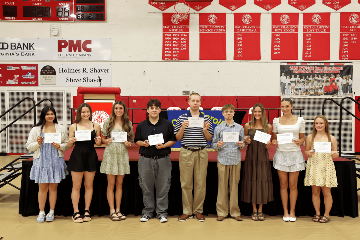 The 2026 Quill & Scroll inductees pose in the Fieldhouse April 28.