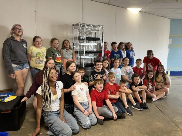 Students in the Native Roots club pose with students from Madison Elementary and the new garden they have made to grow pollinator seeds to help the Monarch butterfly population.