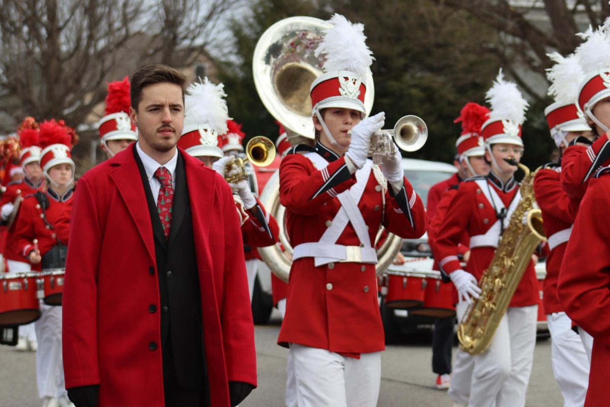 Assistant band director Nic McVaney walks with the band during the Vienna Christmas parade on Grand Central Ave. Dec. 6.