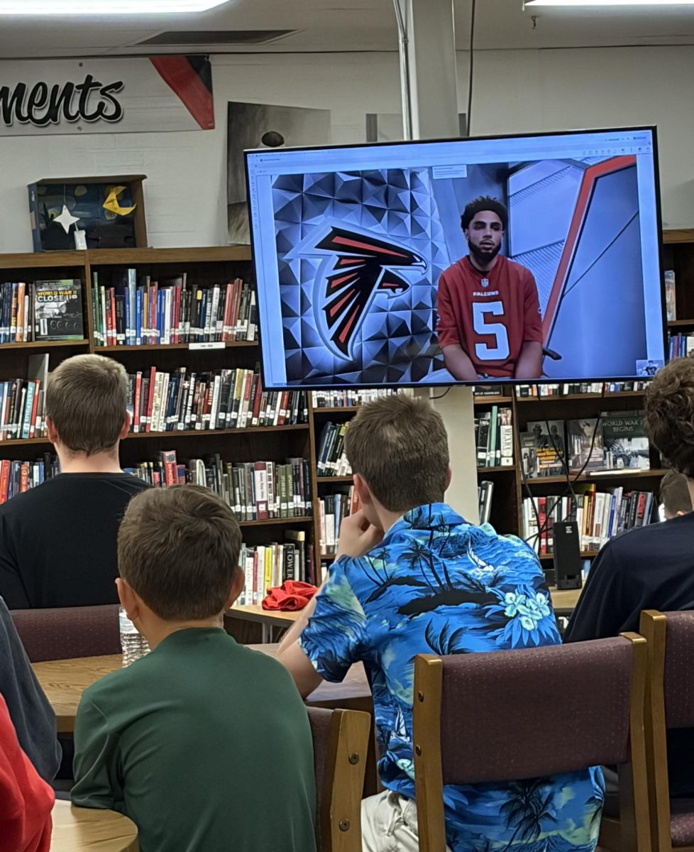 Atlanta Falcons wide receiver Drake London participates in a video interview with Mr. Vincent's Sports in American Culture class during first period April 14 in the library. Moments later, London invited senior Jacob Smith to announce a Falcons draft pick at the NFL Draft in Pittsburgh on April 25.